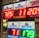 A signboard inside a convenience store displays the current jackpot amounts for various lottery games. There are bright, illuminated numbers in red and green showing the prize amounts: Powerball is at 725 million, Super Lotto Plus at 11 million, Mega Millions at 205 million, Fantasy 5 at 71 thousand, and Daily Derby at 179. In the background, shelves with various drinks and products are visible, along with promotional posters.